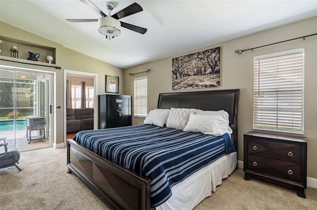 carpeted bedroom featuring ceiling fan, access to exterior, a textured ceiling, and vaulted ceiling