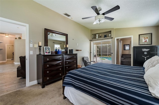 bedroom featuring multiple windows, access to exterior, vaulted ceiling, and ceiling fan