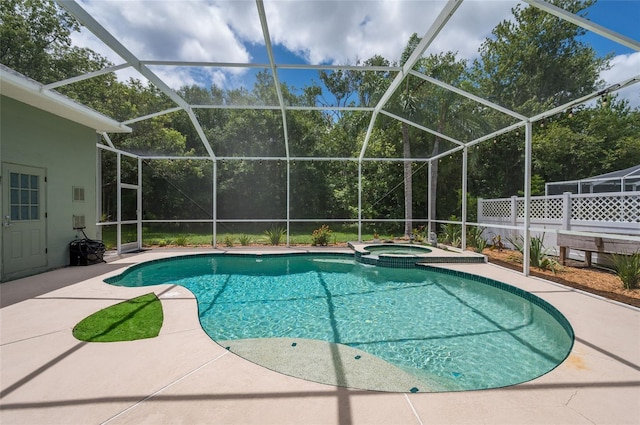 view of swimming pool with an in ground hot tub, a lanai, and a patio area