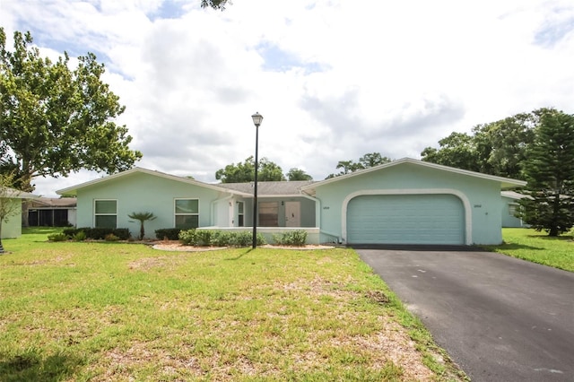 ranch-style home featuring a front lawn and a garage