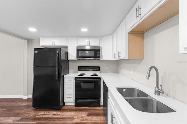 kitchen with black appliances, white cabinets, sink, and dark wood-type flooring