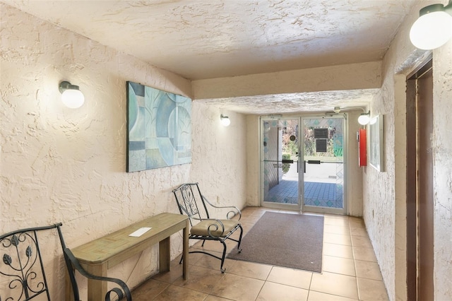 interior space with light tile patterned floors and a textured ceiling