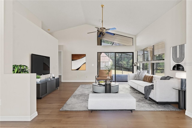 living room with ceiling fan, lofted ceiling, and hardwood / wood-style flooring