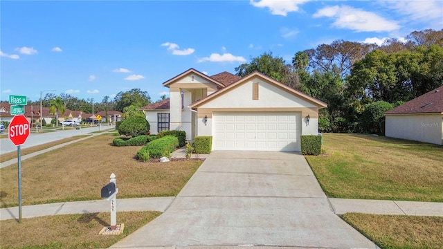 view of front facade featuring a garage and a front yard