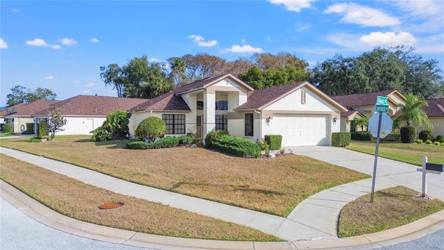 ranch-style home with a garage and a front lawn