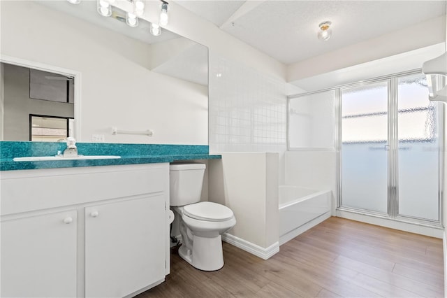 full bathroom with hardwood / wood-style flooring, vanity, independent shower and bath, and toilet