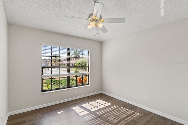 unfurnished room featuring dark hardwood / wood-style floors, a textured ceiling, and ceiling fan