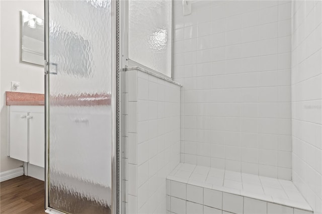 bathroom featuring hardwood / wood-style floors and an enclosed shower