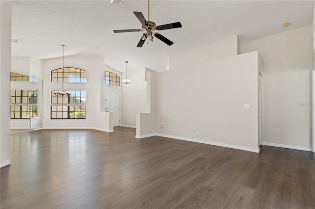 unfurnished living room with dark wood-type flooring, high vaulted ceiling, ceiling fan with notable chandelier, and a textured ceiling