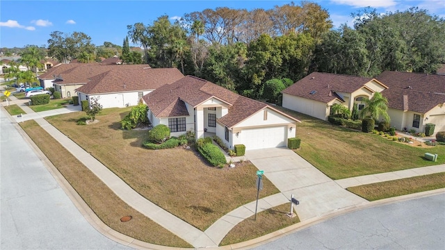 view of front of property with a garage and a front lawn