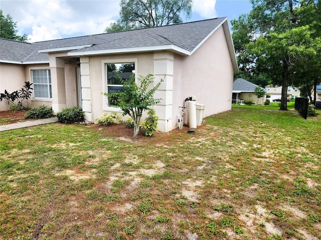 view of side of home featuring a lawn