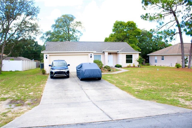 view of front of home featuring a front lawn and a garage