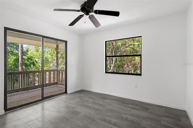 empty room featuring a textured ceiling and ceiling fan