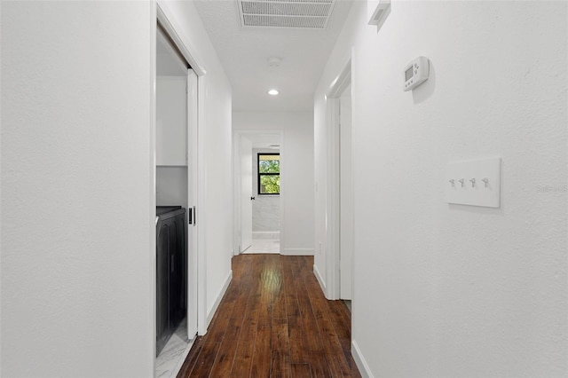 corridor featuring dark hardwood / wood-style flooring