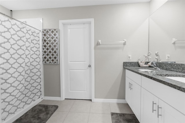 bathroom featuring tile patterned flooring, vanity, and curtained shower