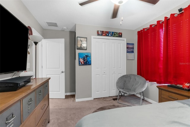 carpeted bedroom featuring ceiling fan and a closet