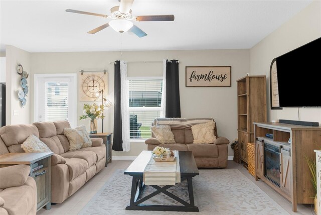 living room featuring light tile patterned floors and ceiling fan