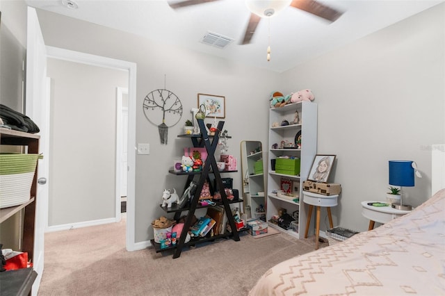 bedroom featuring light colored carpet and ceiling fan