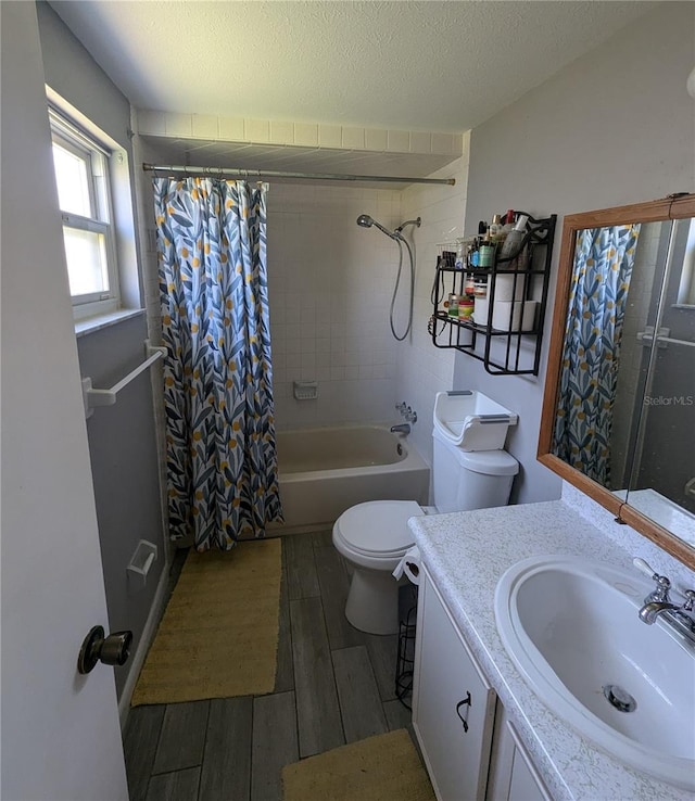 full bathroom with shower / bath combo with shower curtain, a textured ceiling, toilet, vanity, and wood-type flooring