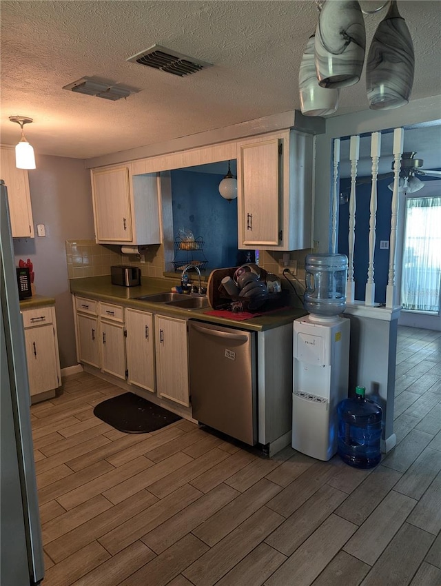 kitchen featuring sink, tasteful backsplash, light wood-type flooring, and stainless steel appliances