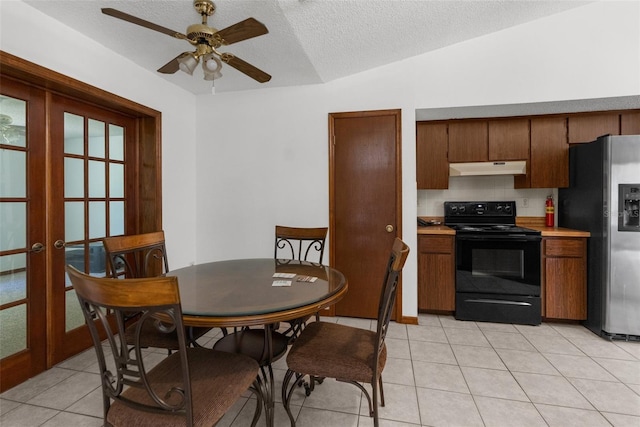 dining space featuring ceiling fan, french doors, a textured ceiling, vaulted ceiling, and light tile patterned flooring