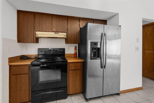 kitchen with electric range, decorative backsplash, light tile patterned floors, a textured ceiling, and stainless steel fridge with ice dispenser