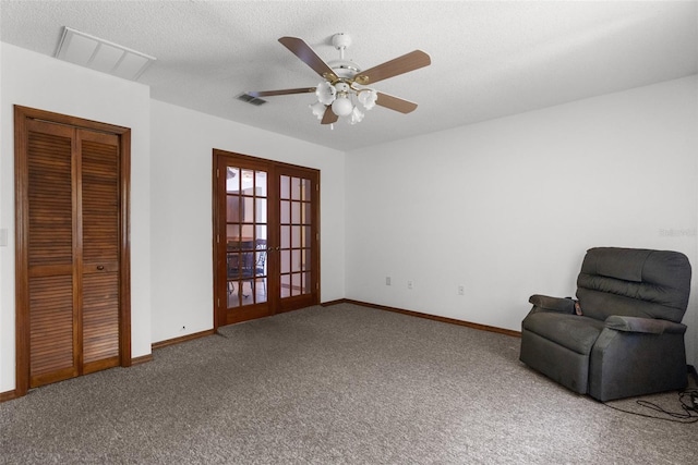 unfurnished room featuring ceiling fan, french doors, carpet, and a textured ceiling