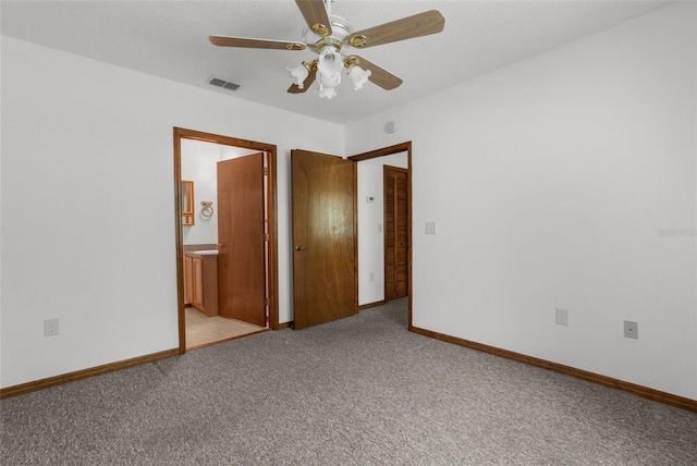 spare room featuring ceiling fan and light colored carpet