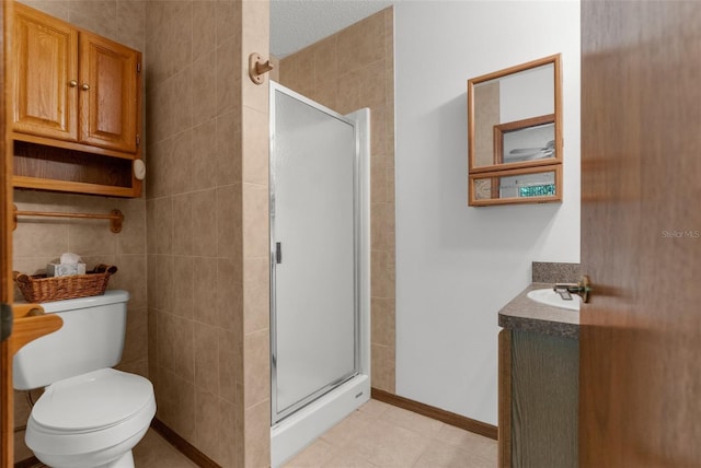 bathroom featuring vanity, toilet, and an enclosed shower