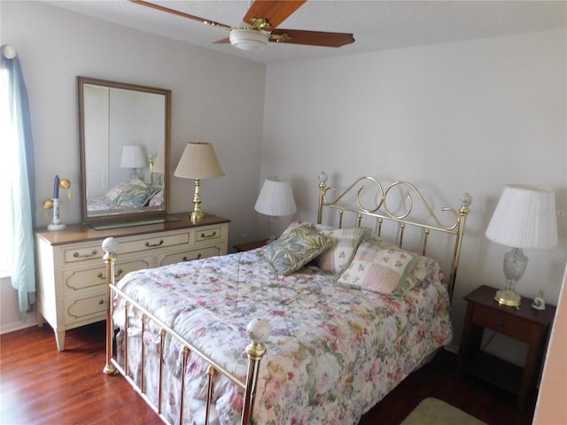 bedroom featuring ceiling fan and dark hardwood / wood-style floors