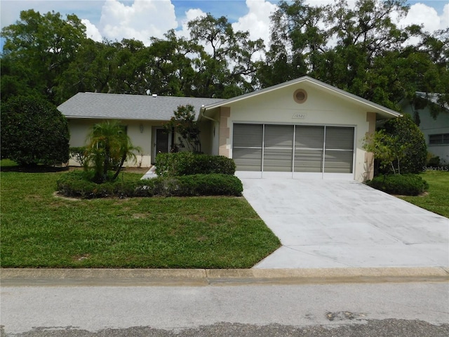 ranch-style house with a garage and a front lawn