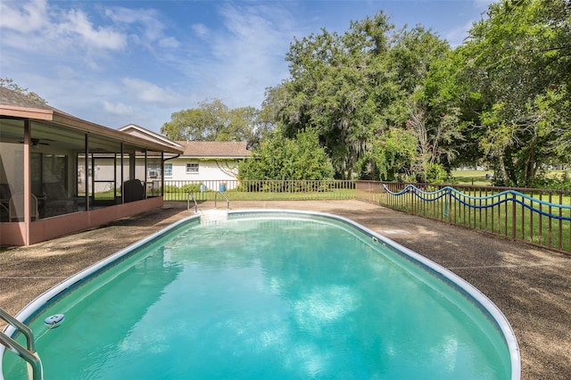 view of swimming pool featuring a sunroom