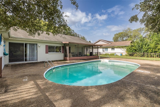 view of pool featuring a patio area and a sunroom