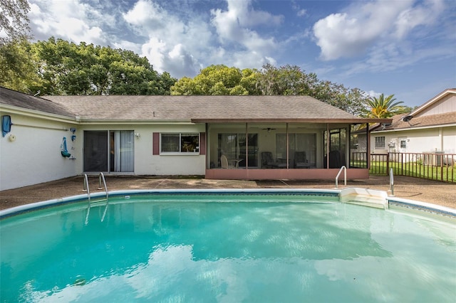 view of swimming pool featuring a sunroom