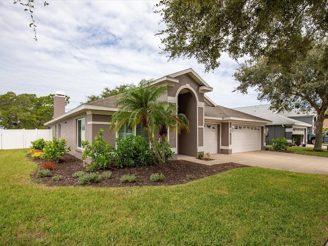 view of front of property with stucco siding, a front lawn, concrete driveway, and a garage