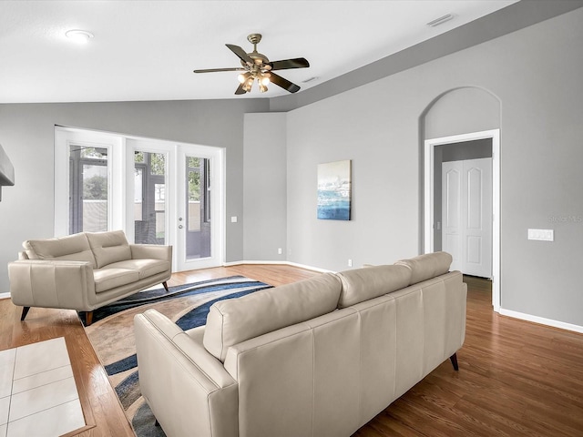 living room featuring lofted ceiling, hardwood / wood-style flooring, and ceiling fan