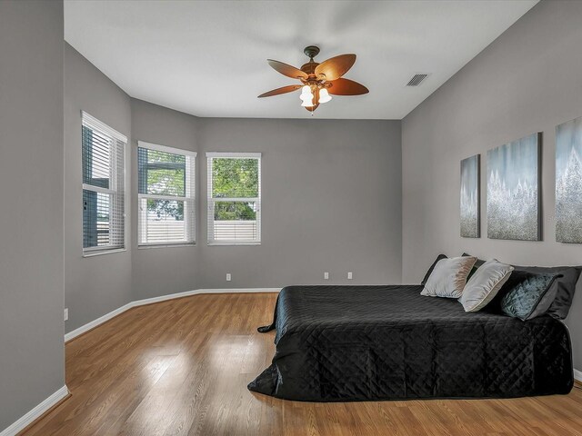 bedroom featuring hardwood / wood-style flooring and ceiling fan