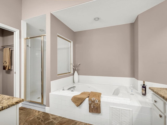 bathroom featuring vanity, shower with separate bathtub, and tile patterned floors