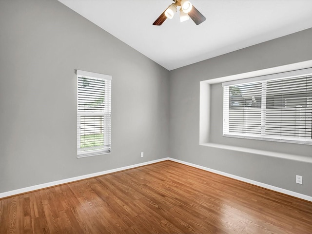 spare room featuring hardwood / wood-style flooring, lofted ceiling, and ceiling fan