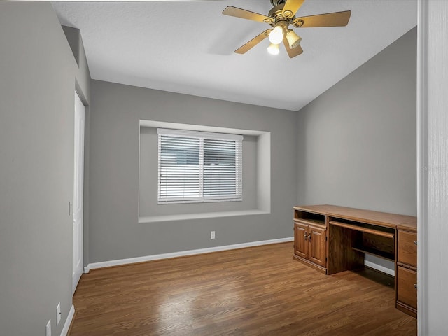 unfurnished office with ceiling fan and wood-type flooring