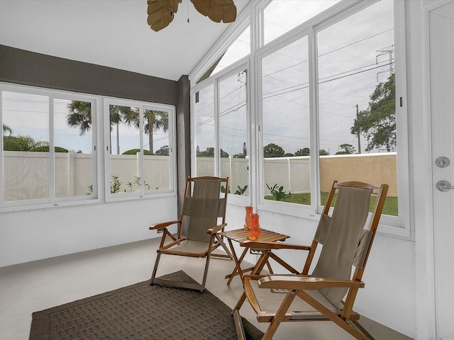 sunroom / solarium featuring lofted ceiling and ceiling fan