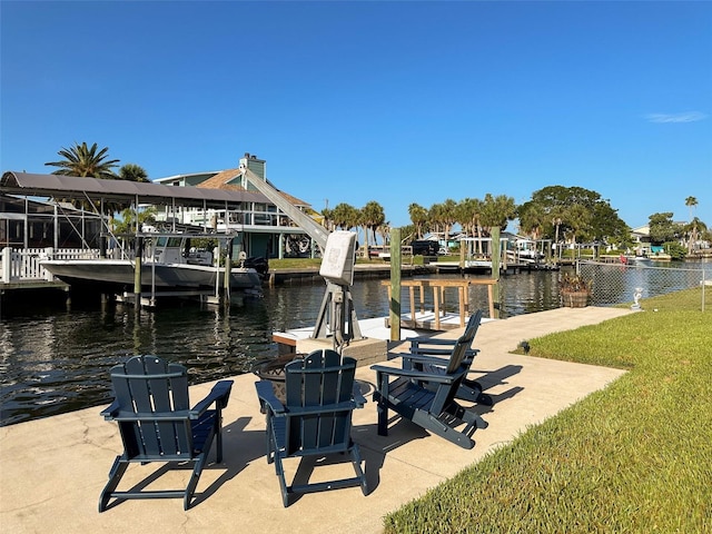 dock area featuring a yard and a water view