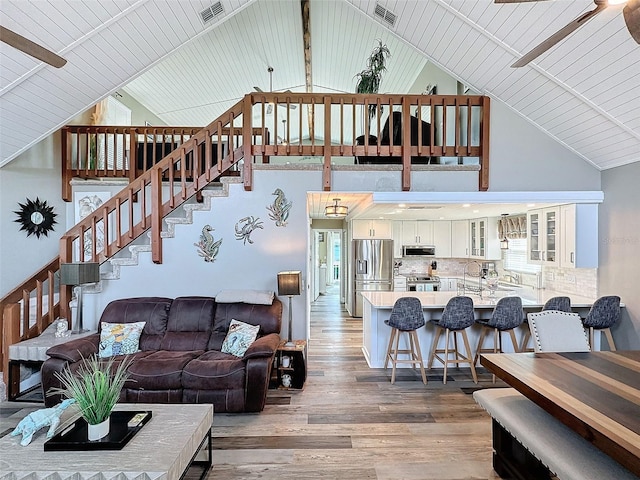 living room featuring wood ceiling, hardwood / wood-style flooring, and high vaulted ceiling