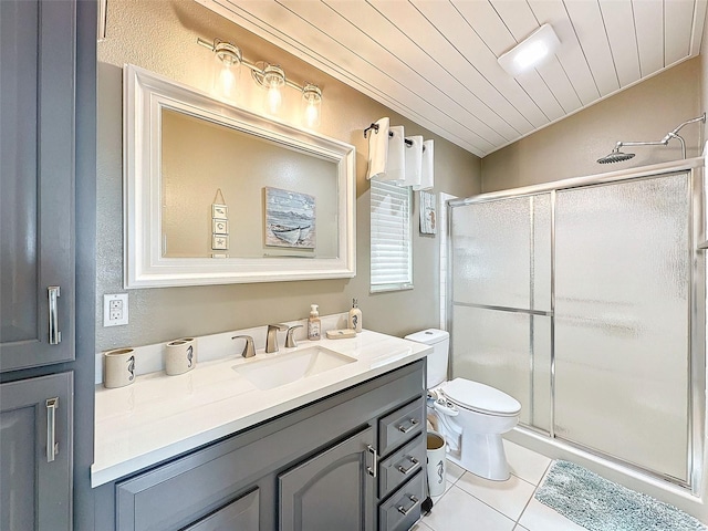 bathroom featuring vaulted ceiling, a shower with shower door, tile patterned flooring, vanity, and toilet