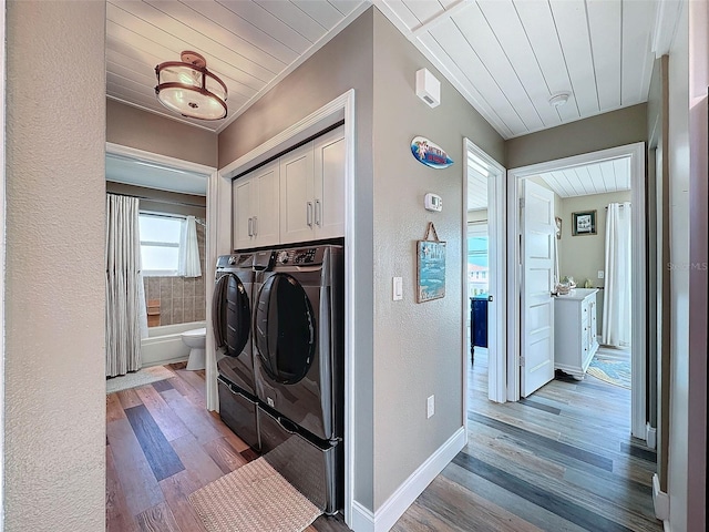 clothes washing area with cabinets, wooden ceiling, independent washer and dryer, and light hardwood / wood-style flooring