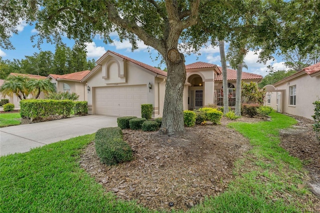 mediterranean / spanish-style home with a garage