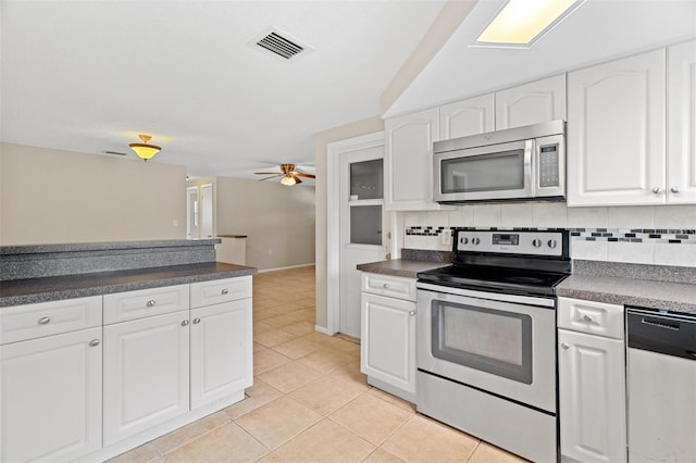 kitchen featuring appliances with stainless steel finishes, backsplash, ceiling fan, light tile patterned floors, and white cabinetry