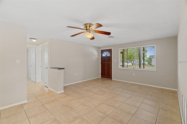 tiled entryway featuring ceiling fan