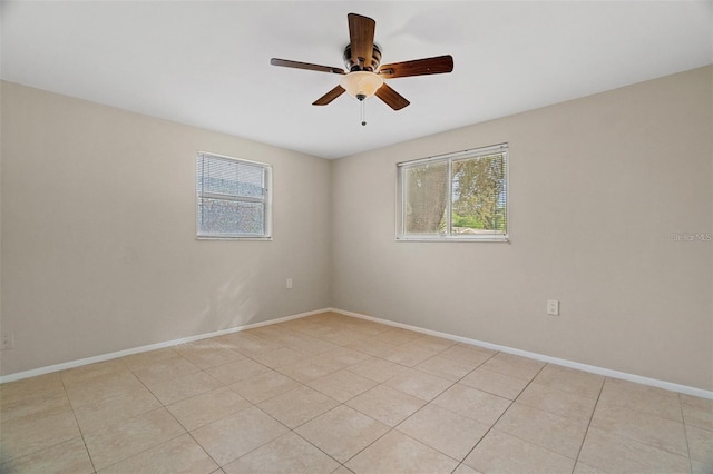 empty room with ceiling fan and light tile patterned flooring