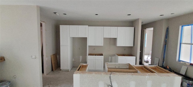 kitchen with white cabinets and a center island